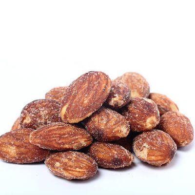 salted and roasted almonds isolated on white background
