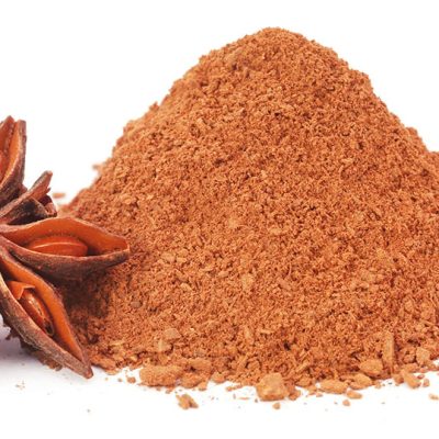 Aromatic star anise with ground spice over white background